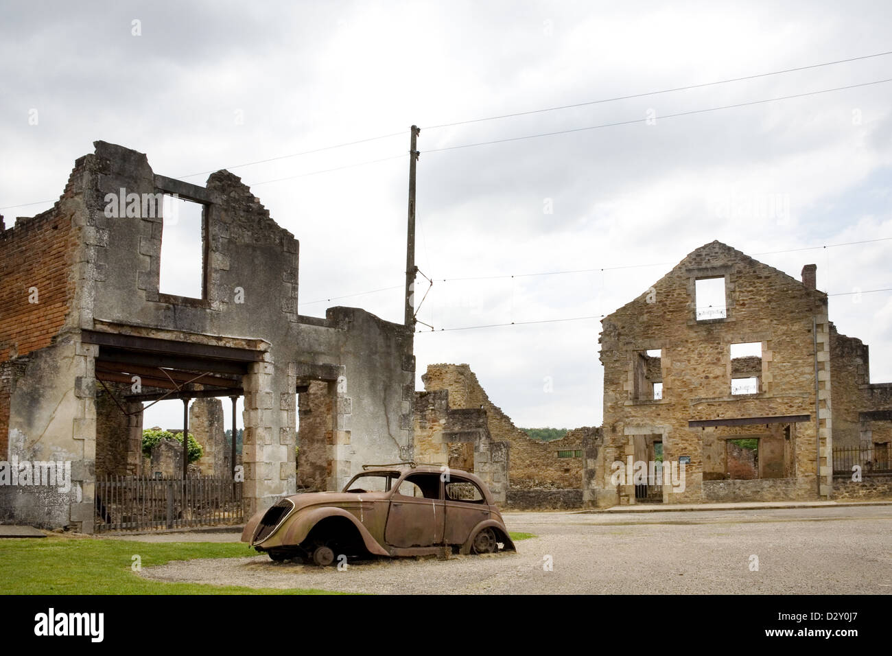 the French village Oradour-sur-Glane. It has been preserved In a Ruined State, buildings and car seen here destroyed by fire. Stock Photo