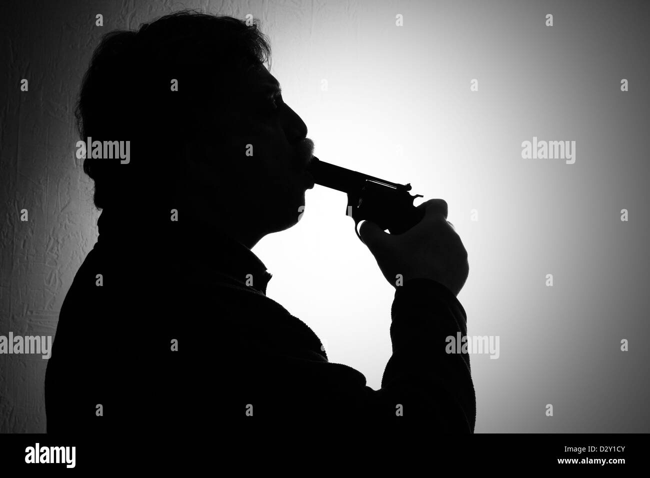 suicide, a man stuck a gun in his mouth, black and white Stock Photo