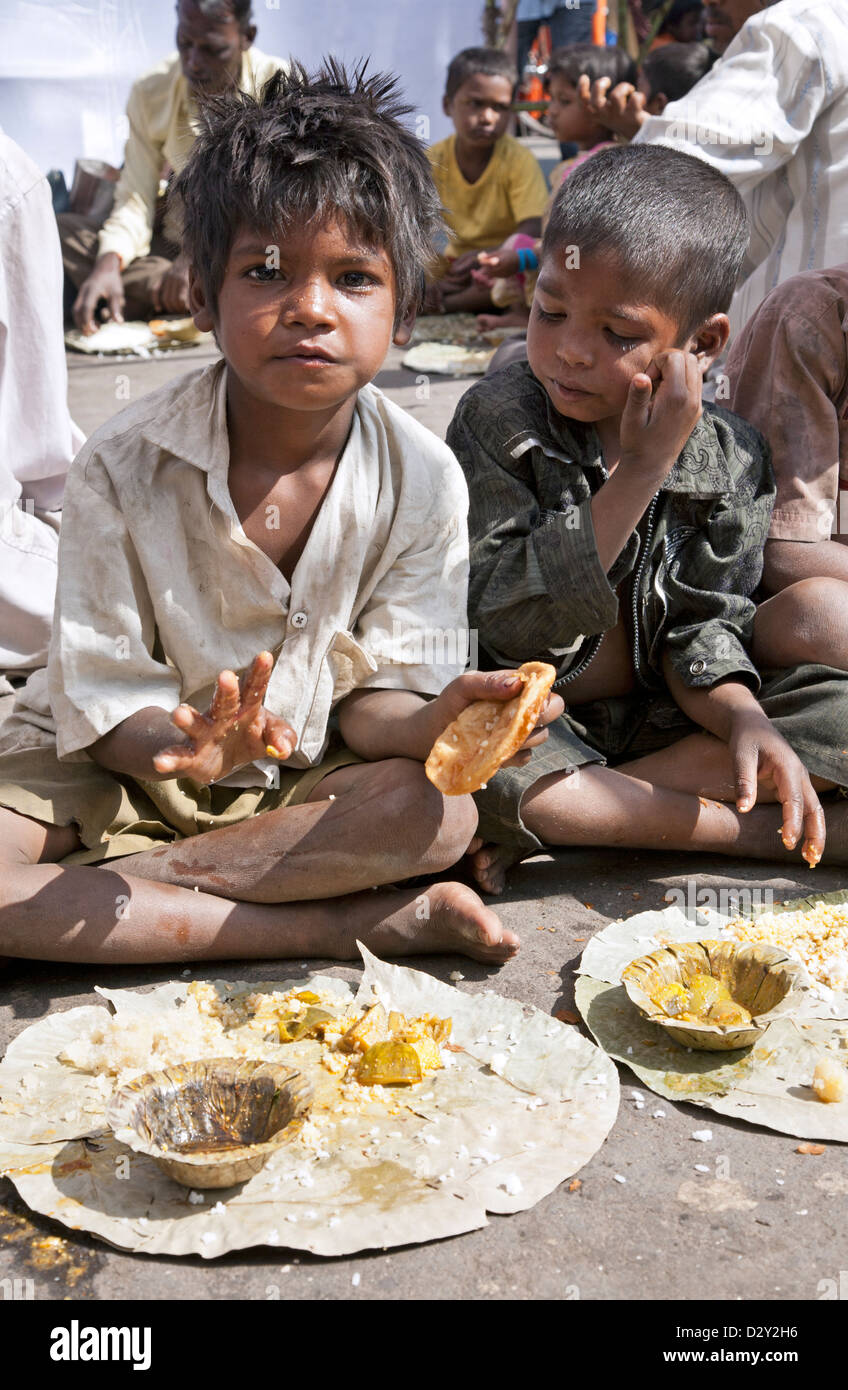 Street children eating charity food. Nasik. India Stock Photo
