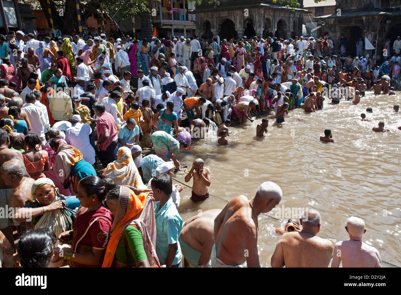 Hindu pilgrims bathing in the sacred  water reservoir of Kushavarta (the source of the Godavari river). Trimbakeshwar. India Stock Photo