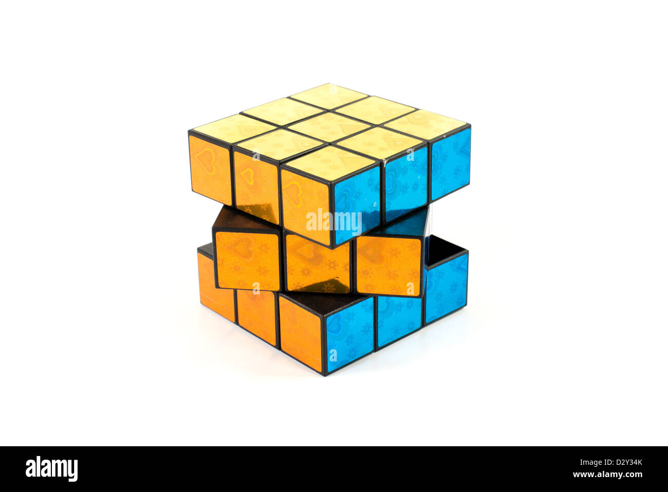 A knockoff Rubick's cube with yellow, gold, and blue sides. Stock Photo