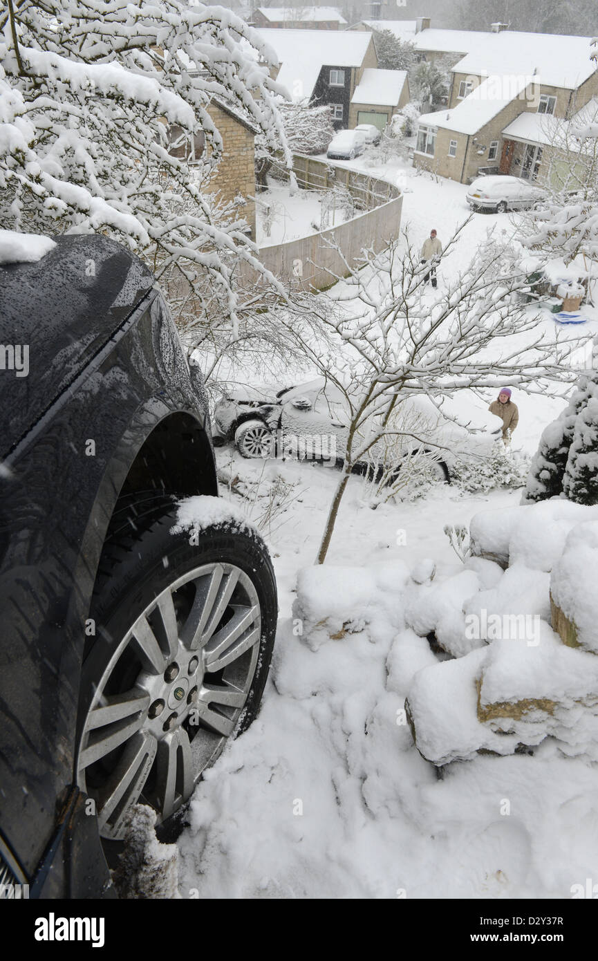 A Range Rover which hit a stationary Vauxhall after sliding in snow forcing it into gardens below on a hill known locally are 'T Stock Photo