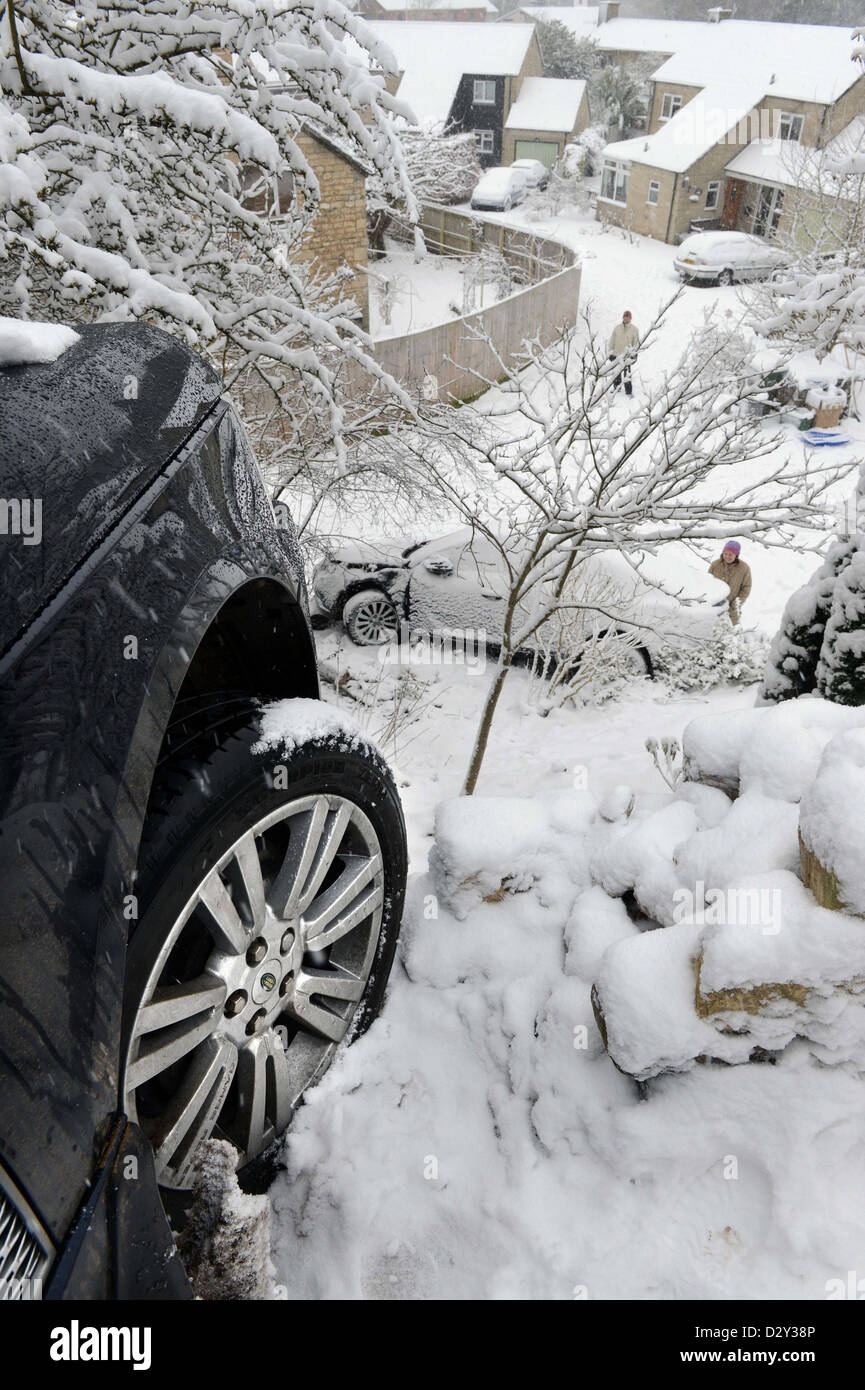 A Range Rover which hit a stationary Vauxhall after sliding in snow forcing it into gardens below on a hill known locally are 'T Stock Photo