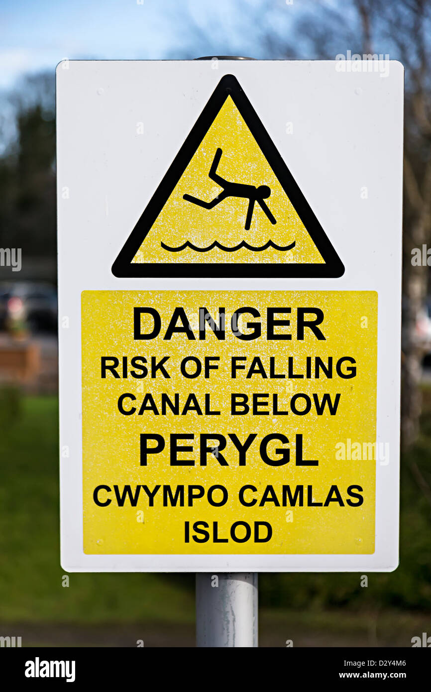 Danger sign risk of falling into canal in English and Welsh language, Cwmbran, Wales, UK Stock Photo