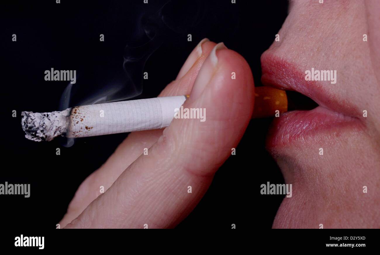 Cigarette smoking illustration close up posed by model (model released). 28 January 2013 Stock Photo
