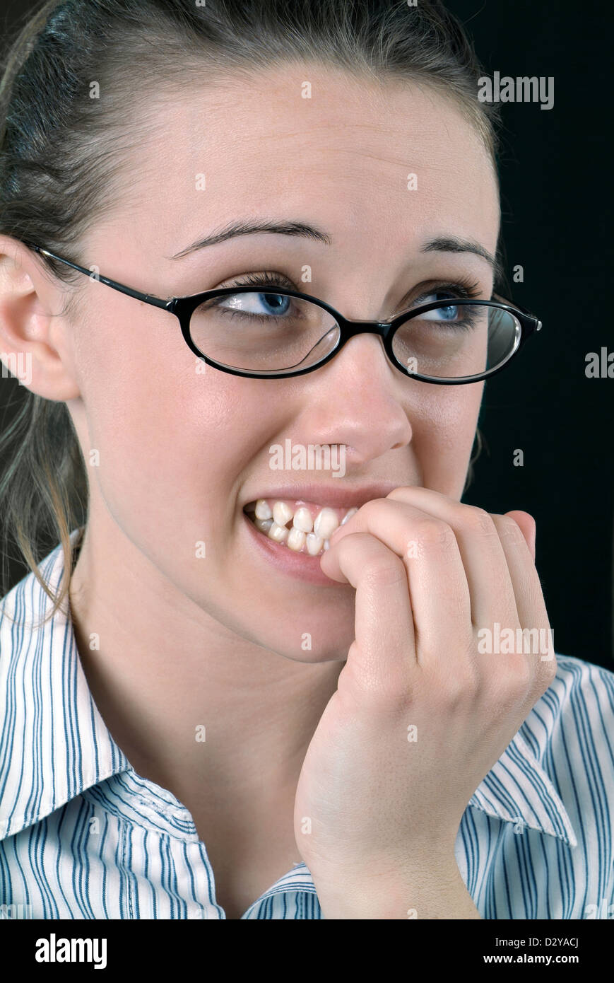 Young office woman looking very nervous Stock Photo - Alamy