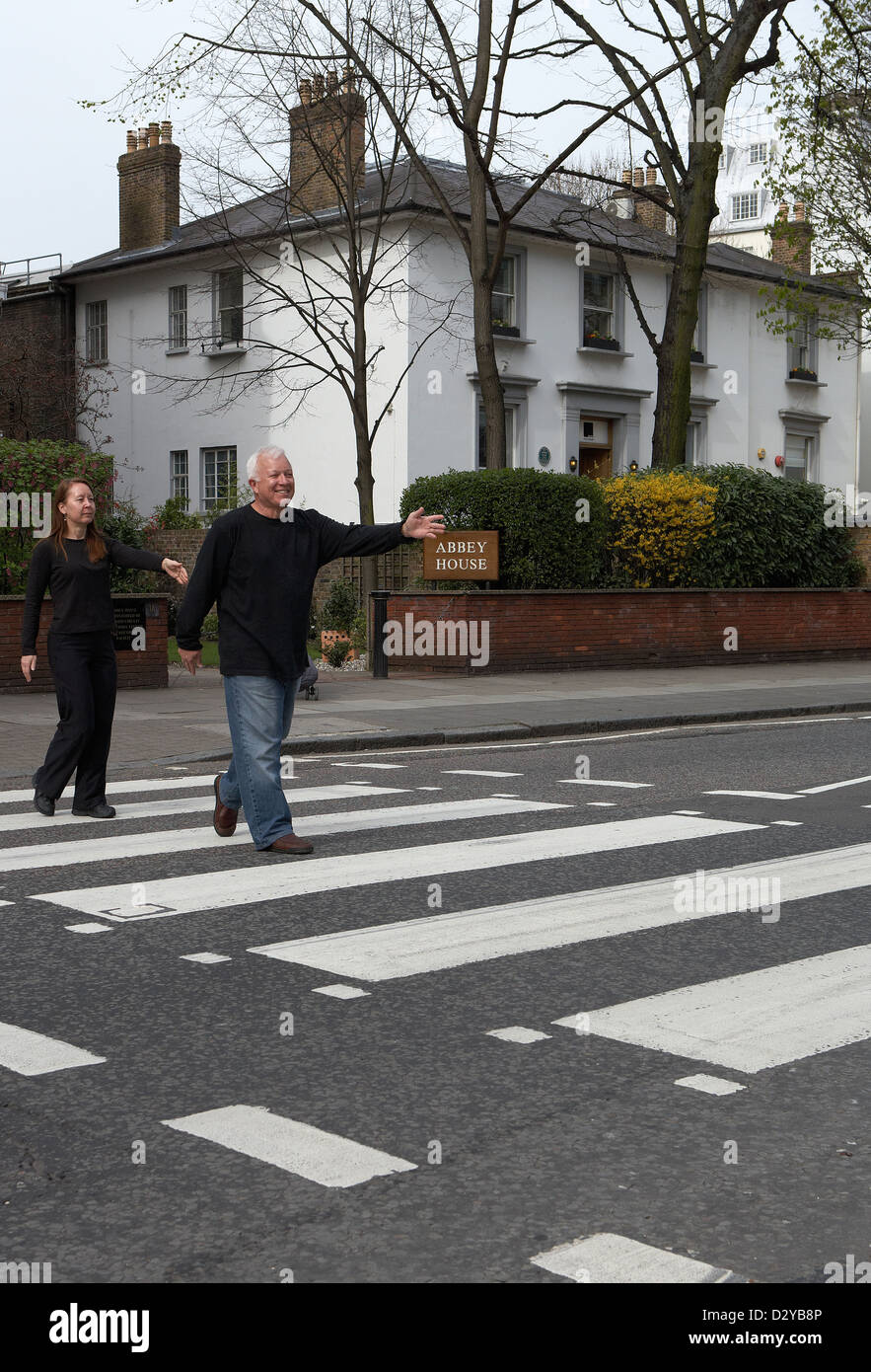 London, United Kingdom, Beatles fans on the zebra crossing in front of Abbey Road Studios Stock Photo