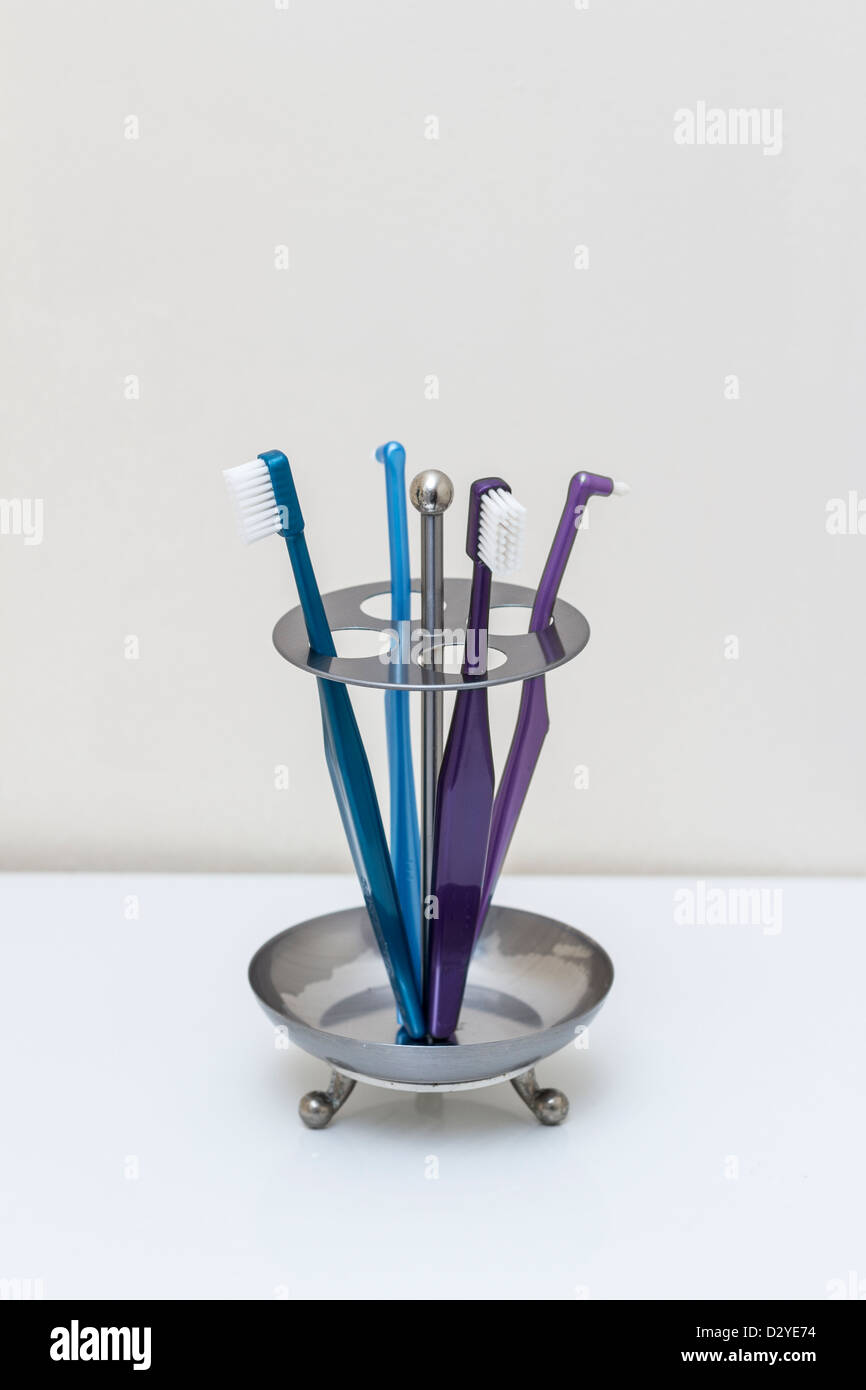 Toothbrushes in bathroom Stock Photo