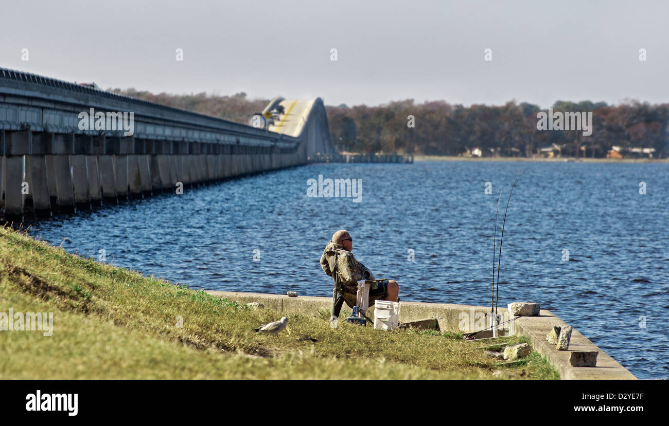 St. Johns River scenic in North Florida.  Fisherman relaxing near the highway 16 bridge. Stock Photo