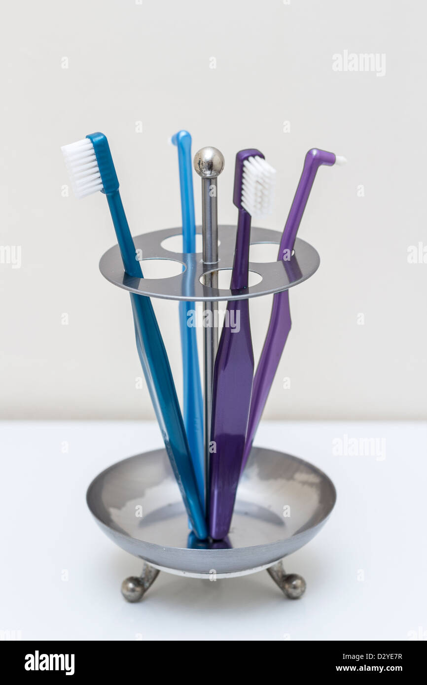 Toothbrushes in bathroom Stock Photo