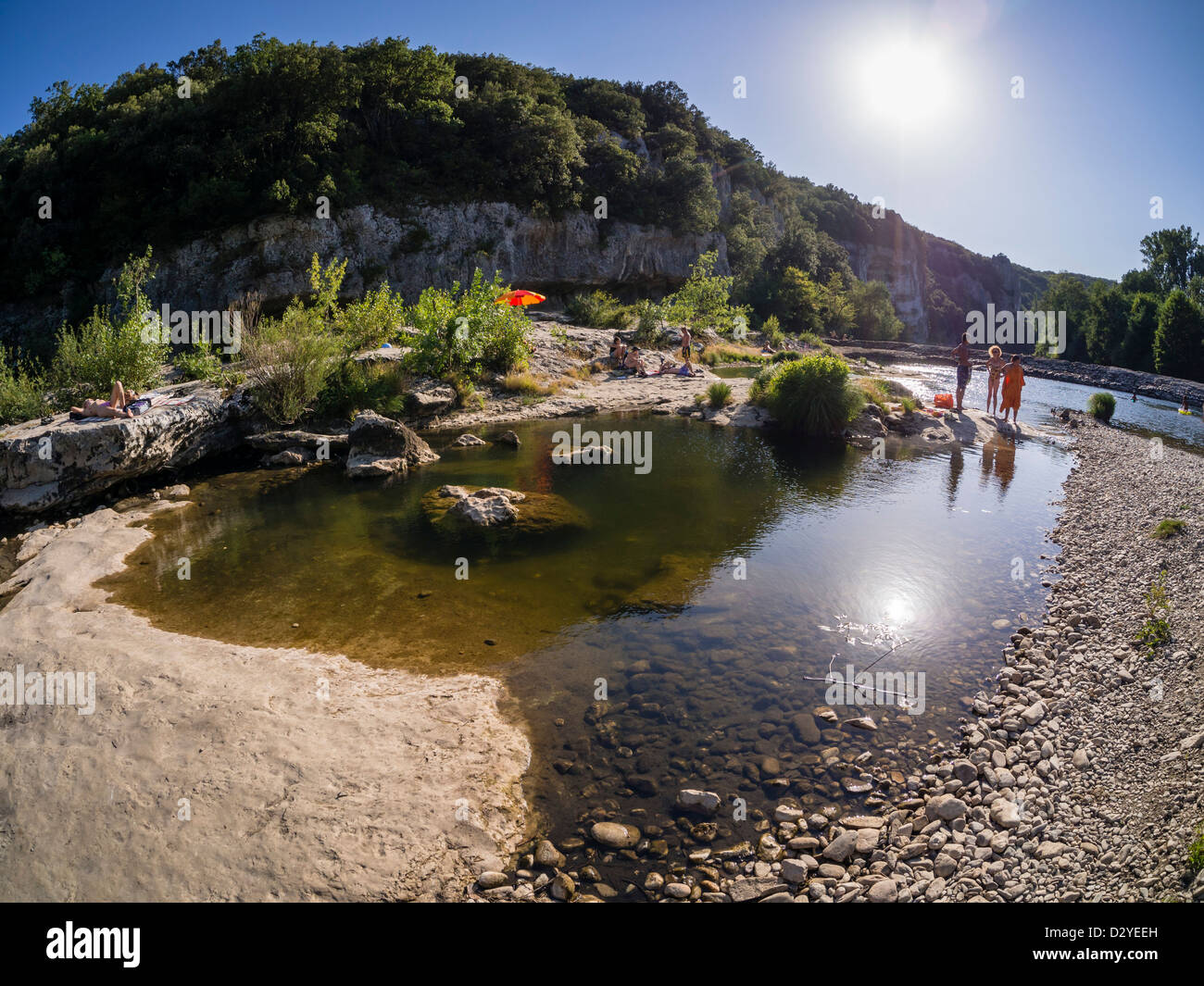 Vacationists enjoy their summer holidays at the banks of the river Cèze in Southern France. Stock Photo