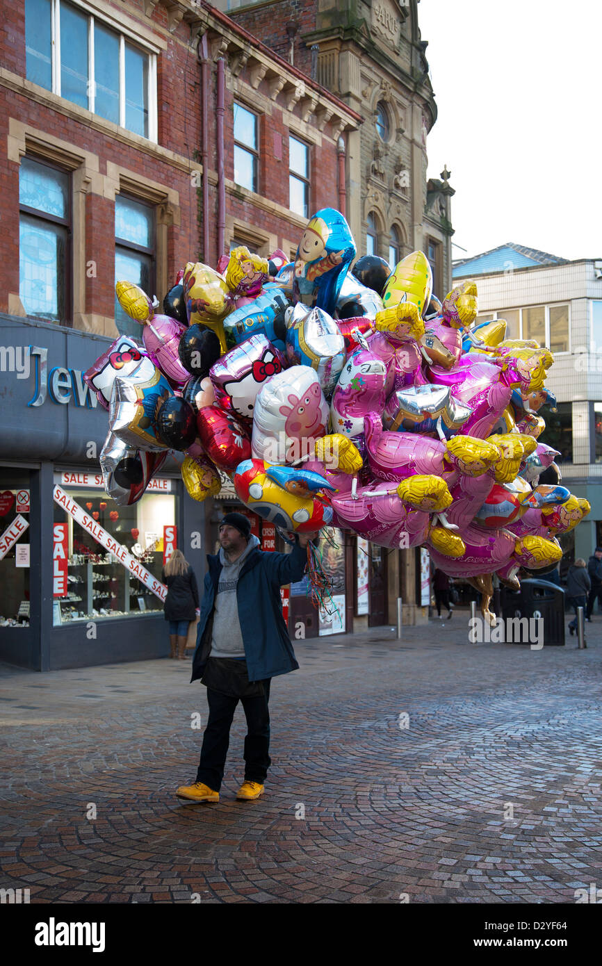 Balloon seller selling inflated Helium Balloons on the streets of