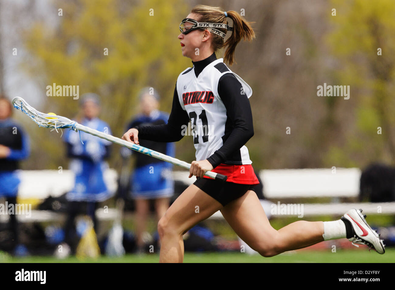 A Catholic University player attacks during a lacrosse game against
