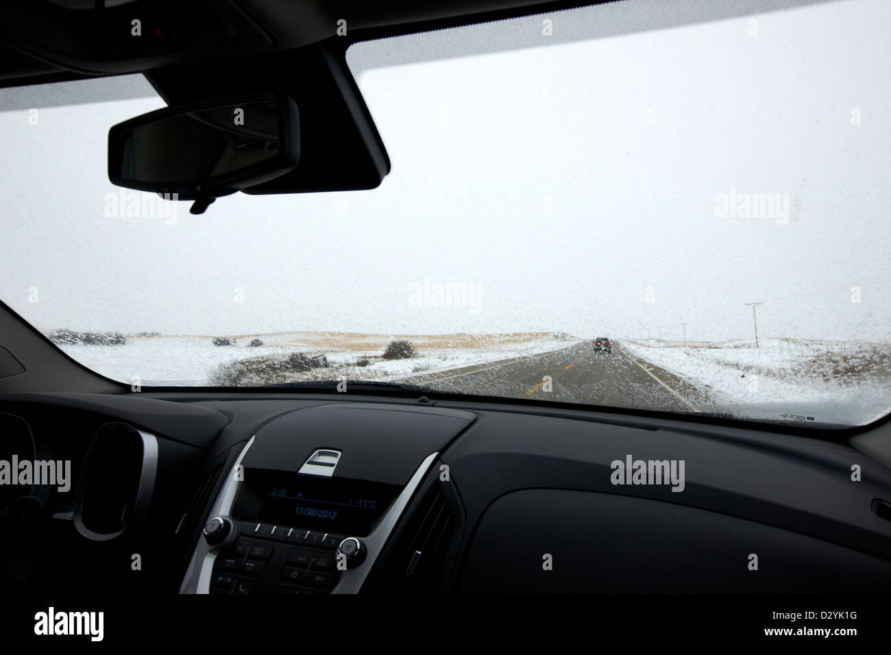 driving along single road highway in freezing rain bad driving conditions near Biggar Saskatchewan Canada Stock Photo