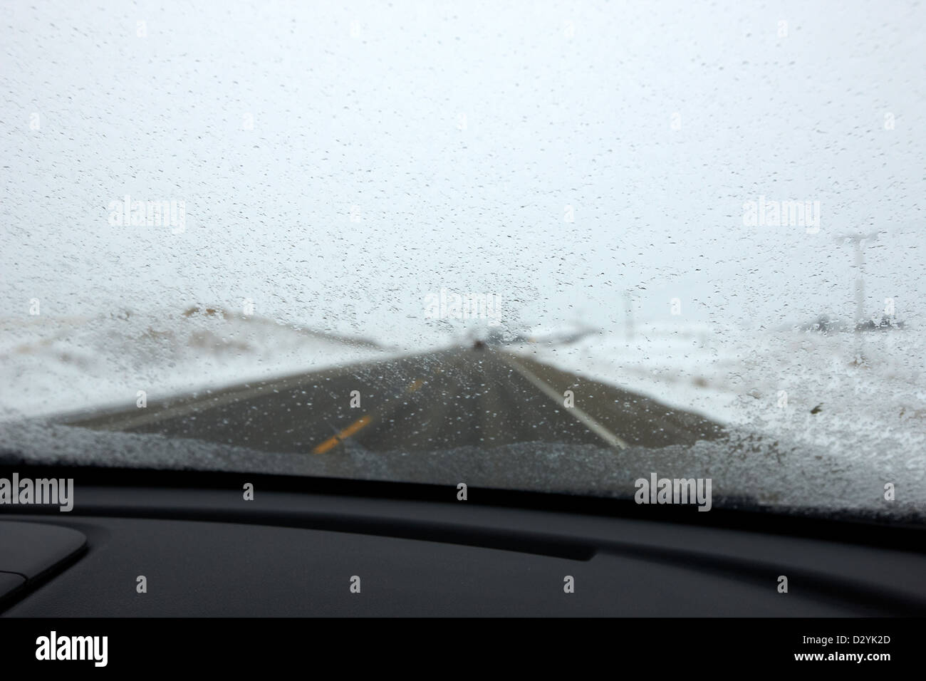 driving along single road highway in freezing rain bad driving conditions near Biggar Saskatchewan Canada Stock Photo