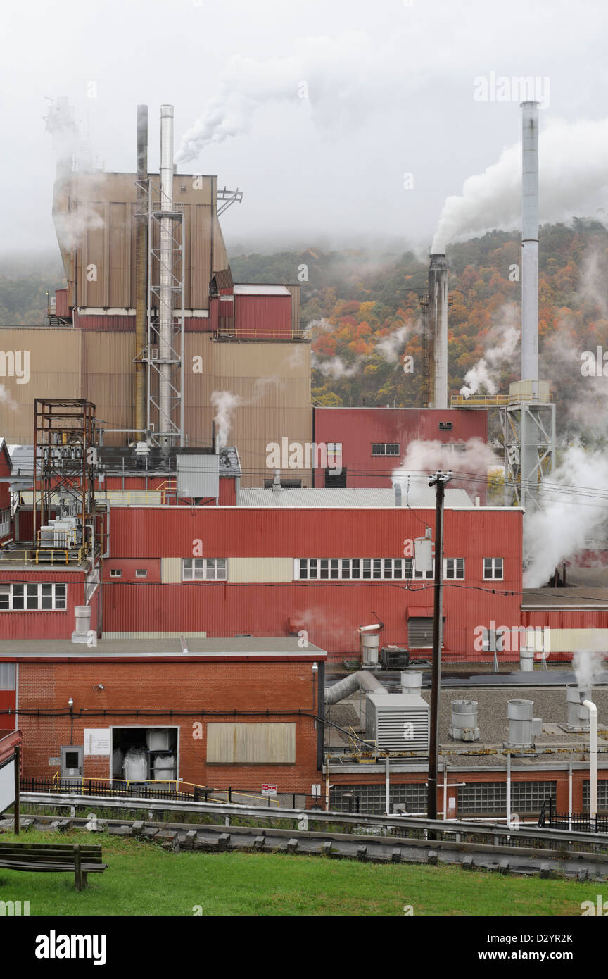 Modern factory showing steam and smoke rising, a manufacturing plant on ...
