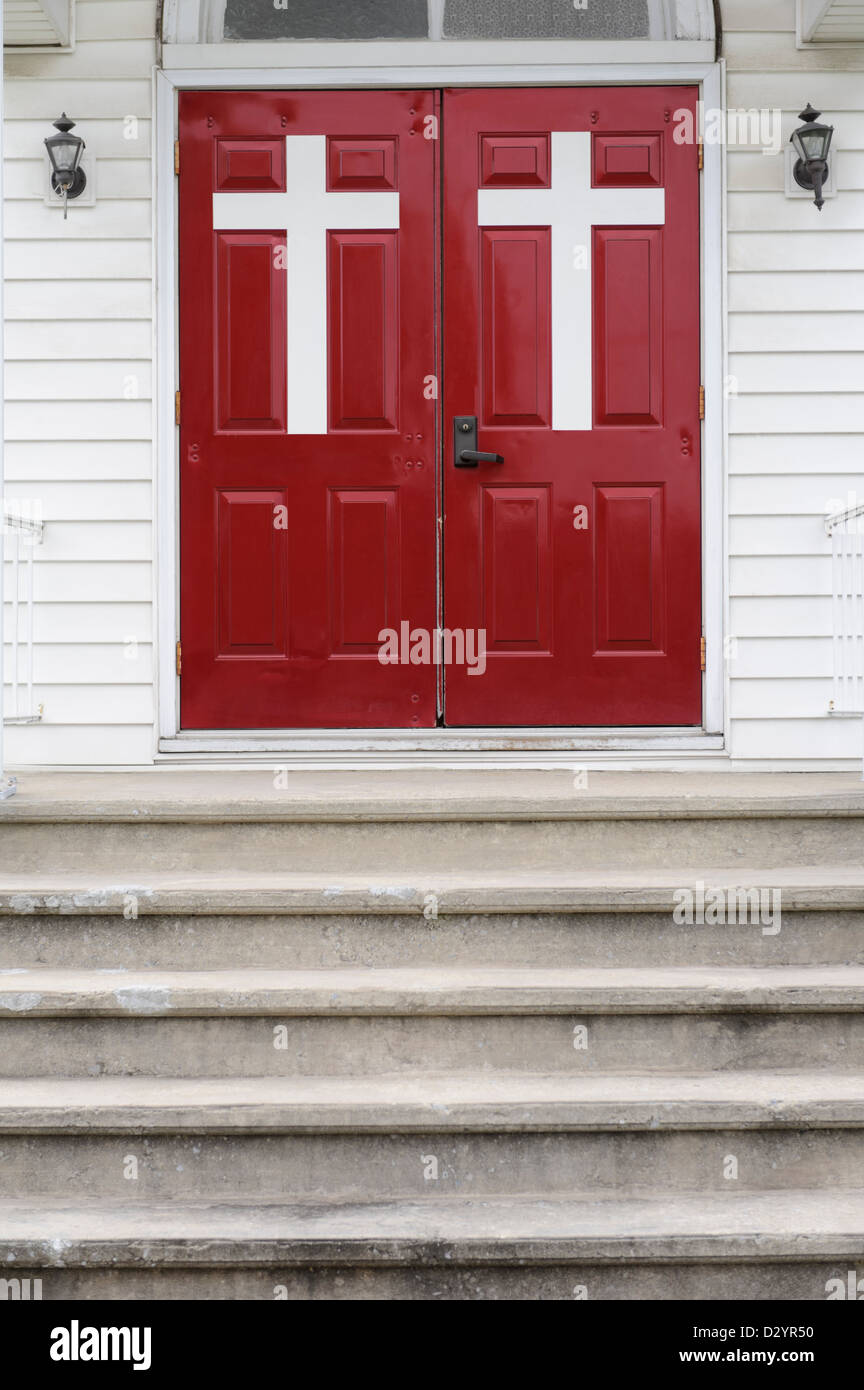 Church doors with large white crosses and steps leading to the entrance