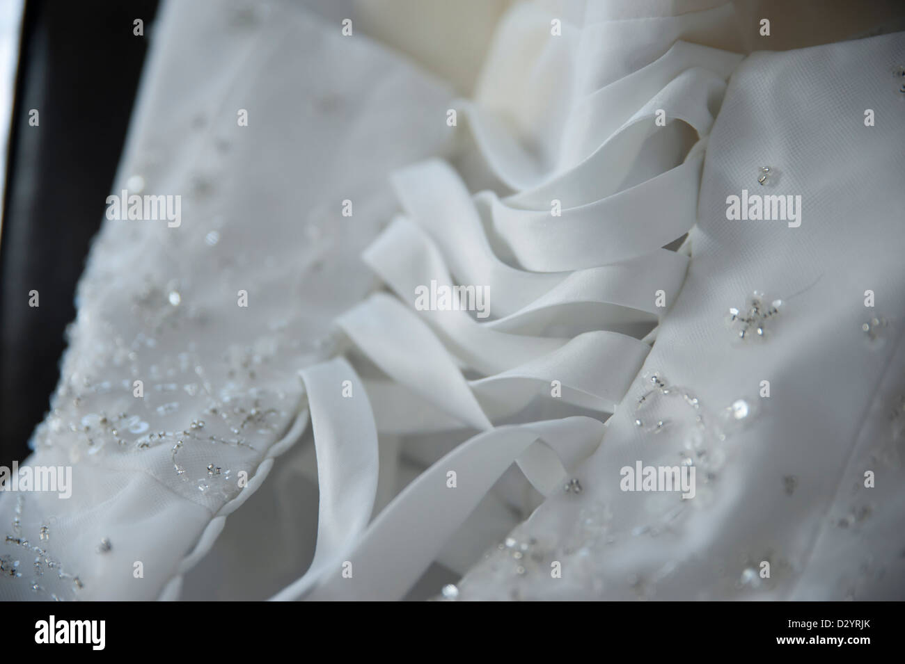 Laces on the back of a wedding dress for lacing it up Stock Photo