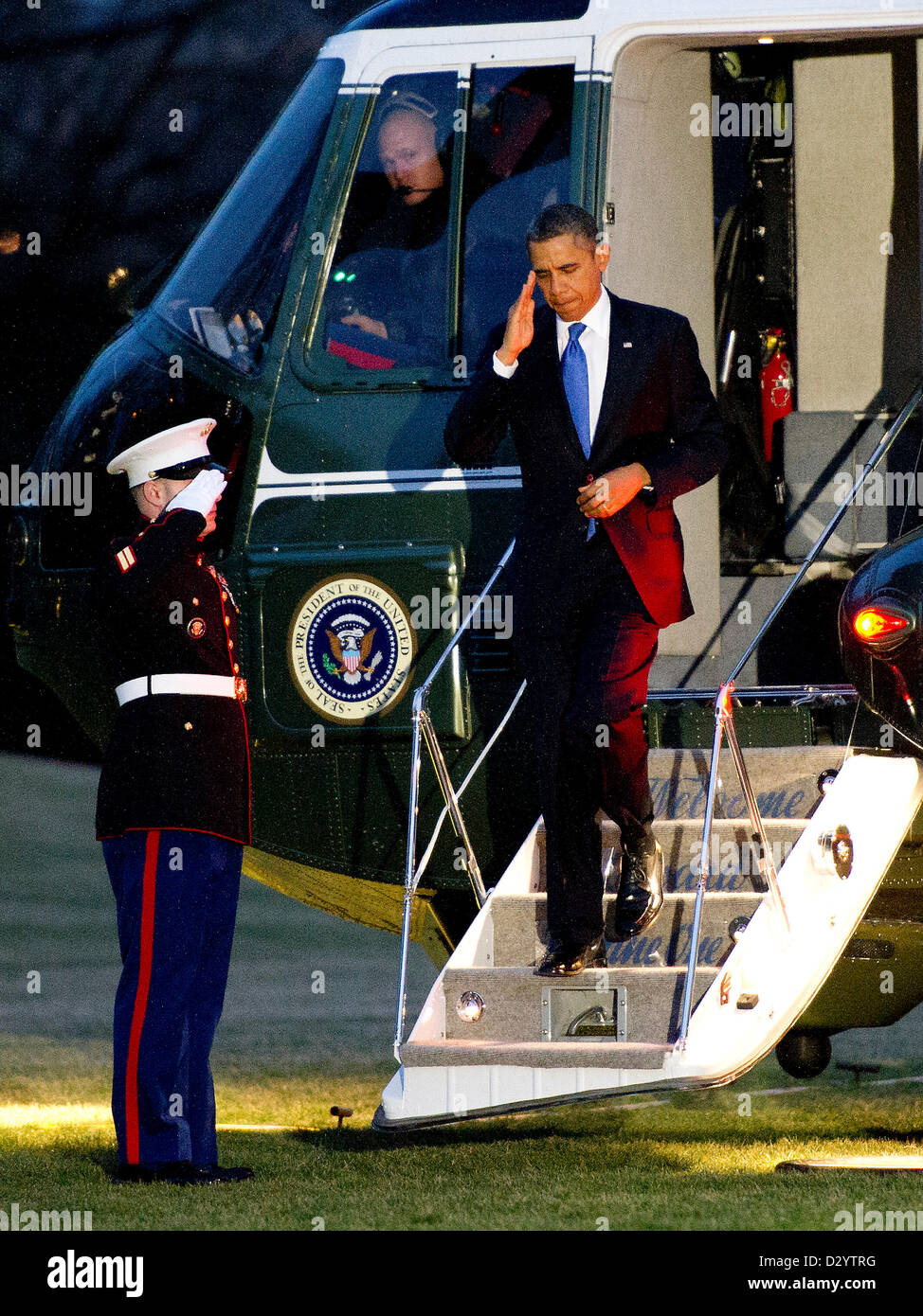 United States President Barack Obama salutes the Marine Guard as he ...