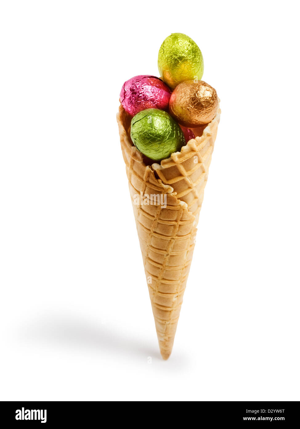 Waffle cone with colorful chocolate candy Easter eggs wrapped in foil