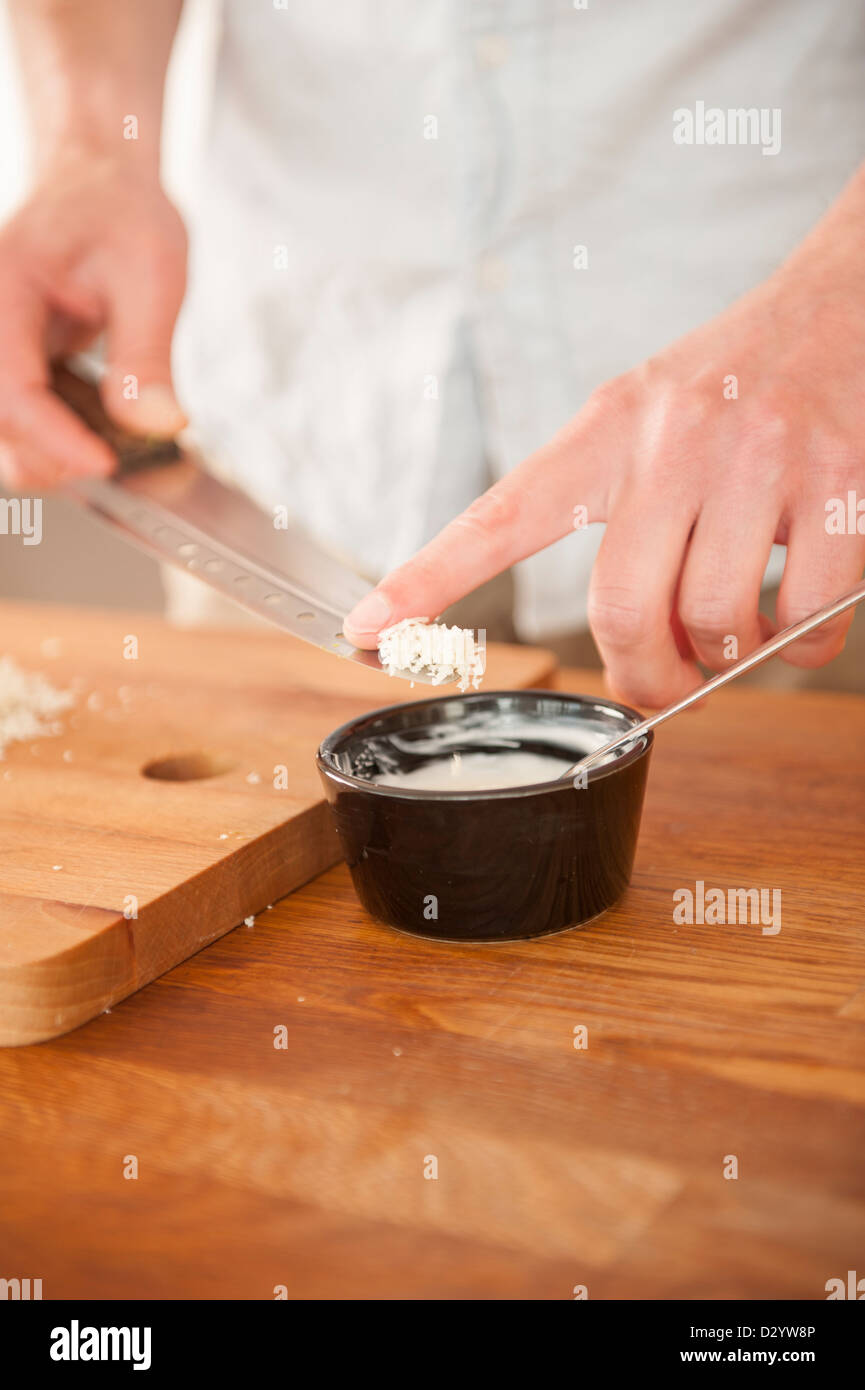 Chef making creamy sauce with sour cream and grated horseradish Stock Photo