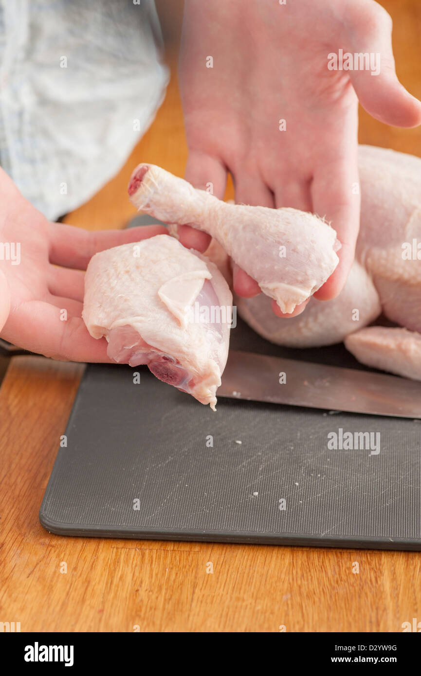 Chef cutting a raw chicken Stock Photo