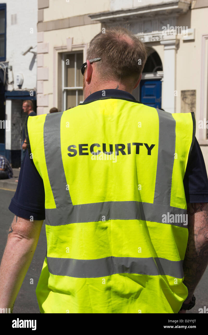 Security man on duty on the Gloucester Carnival 2012 procession route stationed on Hampden Way. Stock Photo