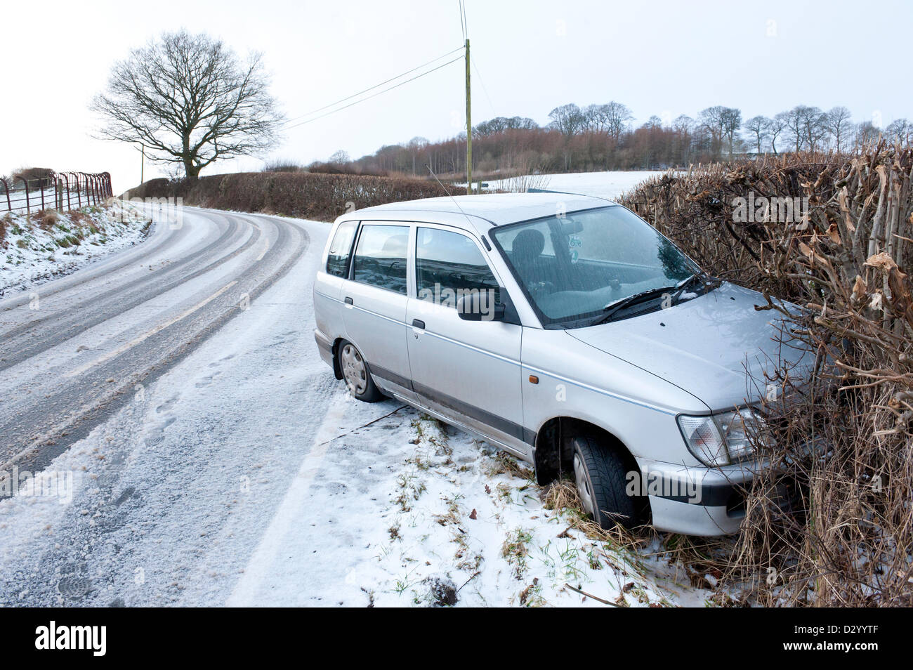 Cambrian Mountains, Wales, UK. 5th February, 2013. A motorist has lost control on the fresh snow and ice at Llandwier Cwm two miles from Builth Wells, Powys. After 10 days of unseasonal mild wet and windy weather, Wales was hit last night and this morning by thunderstorms, and blizzard conditions. Most of the precipitation was in the form of hail and sleet. Photo credit: Graham M. Lawrence/Alamy Live News. Stock Photo