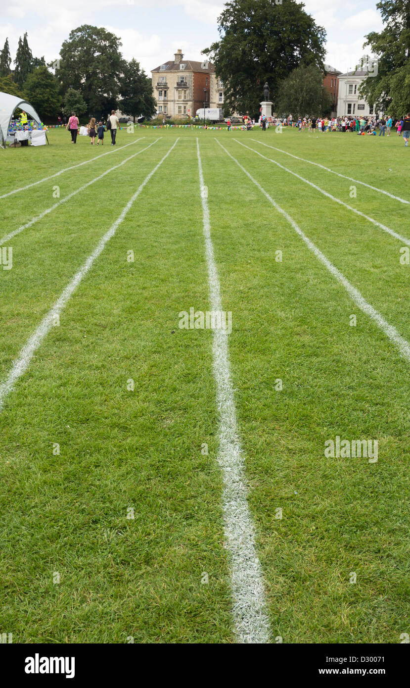 Running track lanes marked on the on the grass at Gloucester Park for fun events at the Gloucester Carnival 2012. Stock Photo