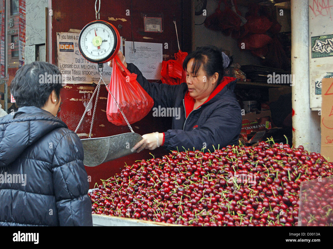 Canal Street, Chinatown, New York City. Cherries for sale, 4 pounds for 5 dollars. Stock Photo