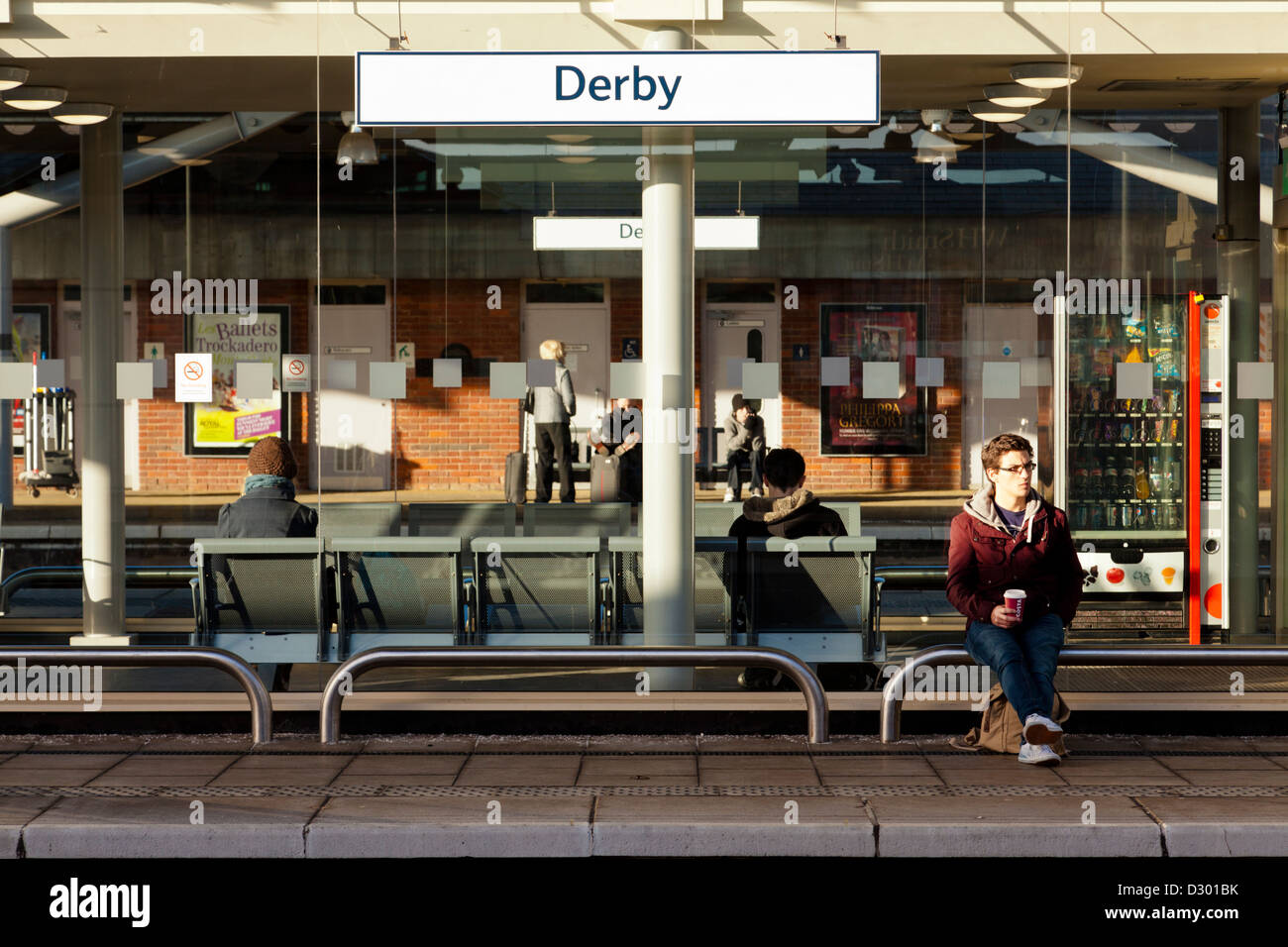 Passengers waiting for a train at Derby Railway Station, England, UK