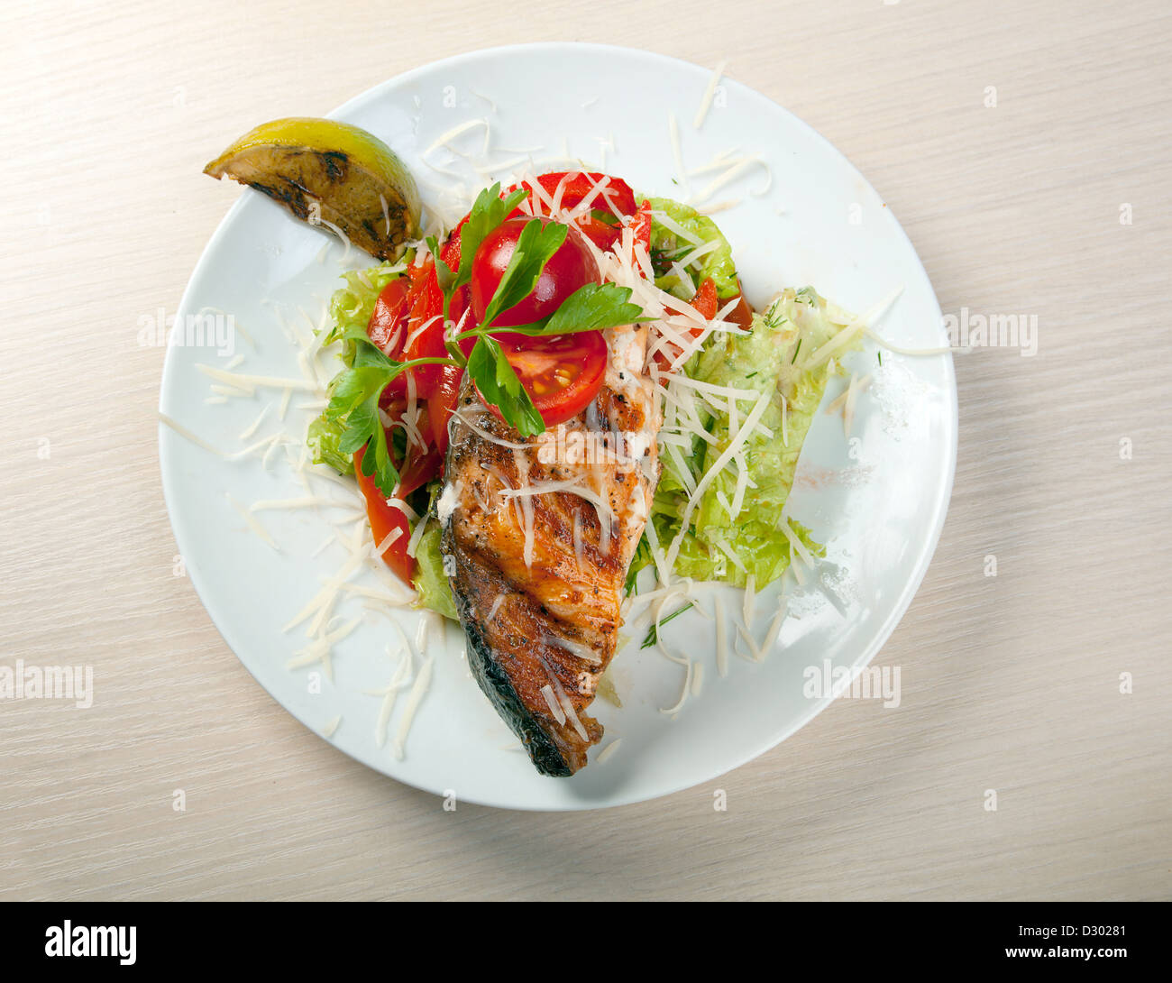 Grilled salmon steak and vegetables served on plate Stock Photo - Alamy