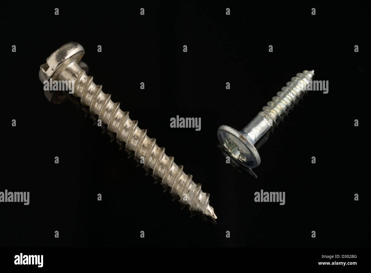 two screws on black background Stock Photo