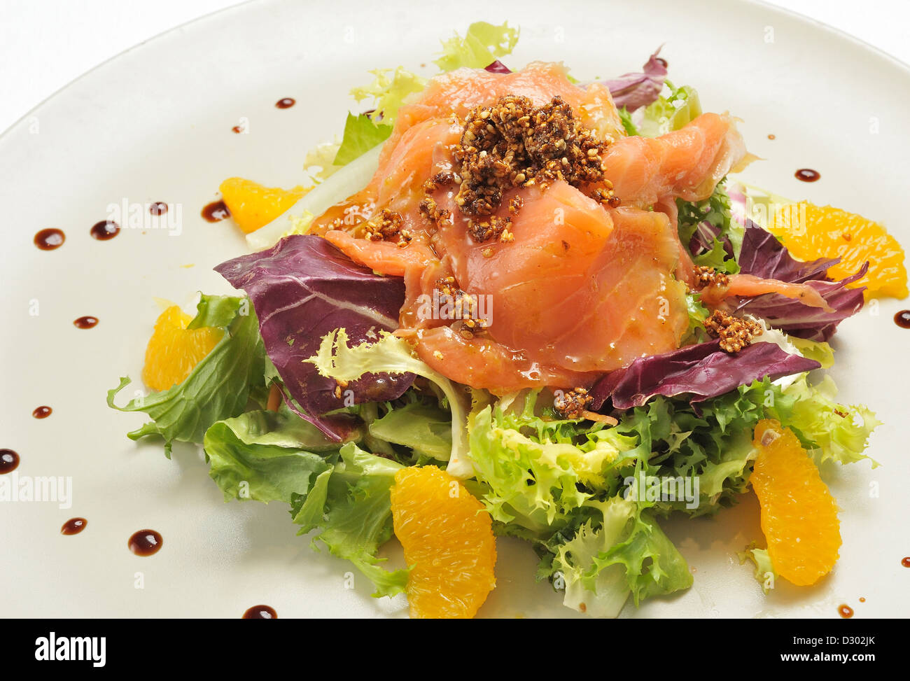 salmon salad with lettuce and escarole with tangerine segments Stock Photo