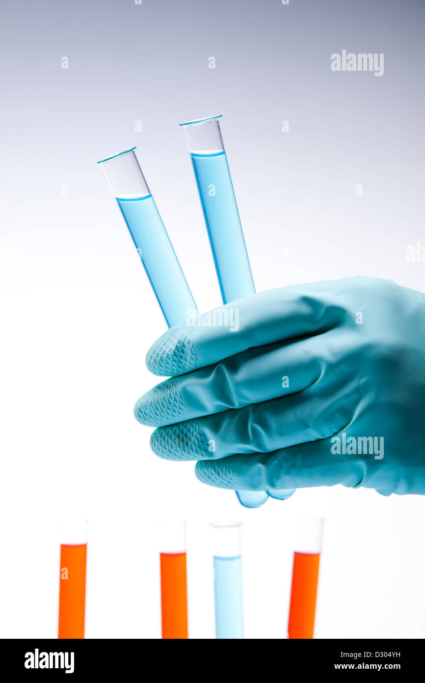 Scientist in laboratory examinates samples and chemical fluids Stock Photo