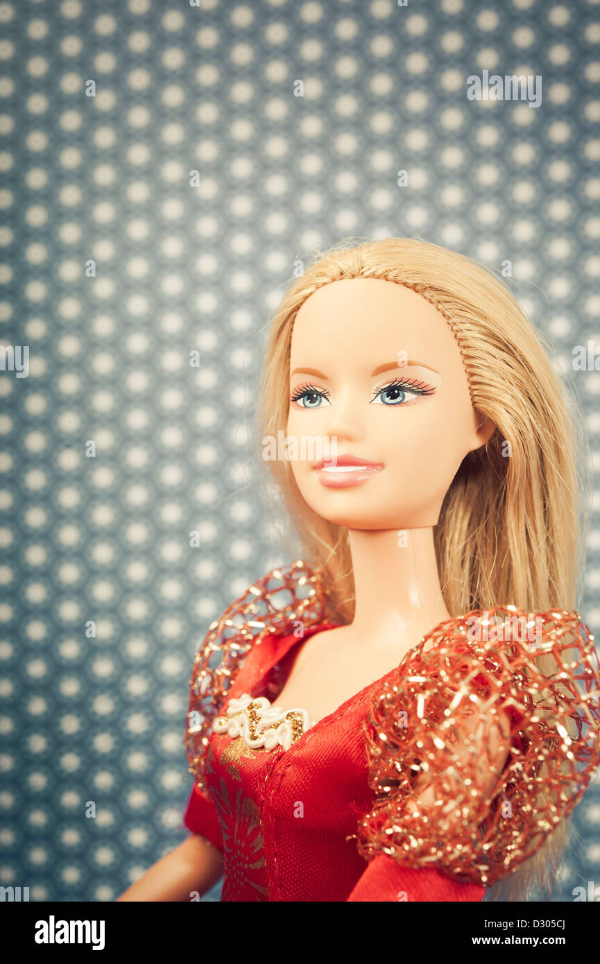 head and shoulder of a Barbie doll in red dress Stock Photo