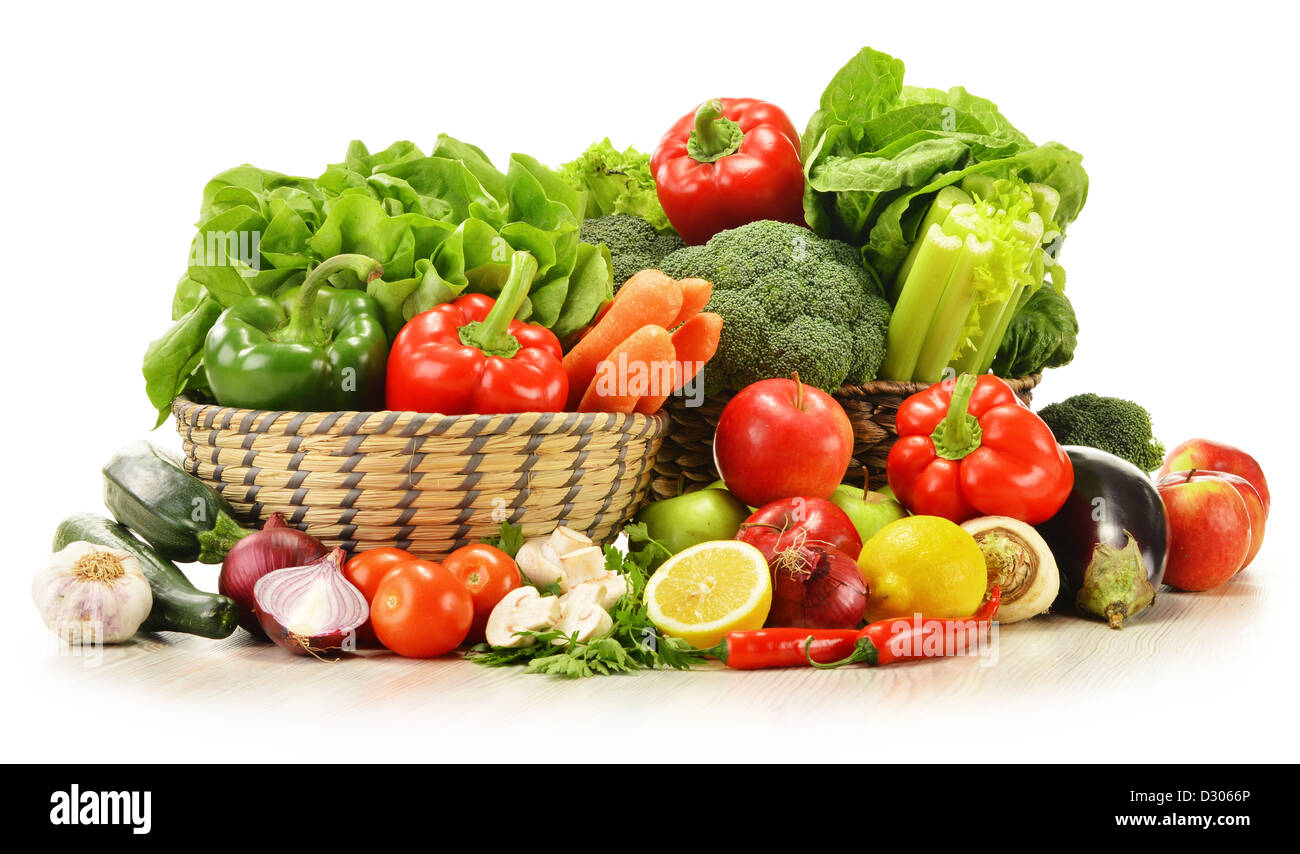 Composition with raw vegetables in wicker basket isolated on white ...