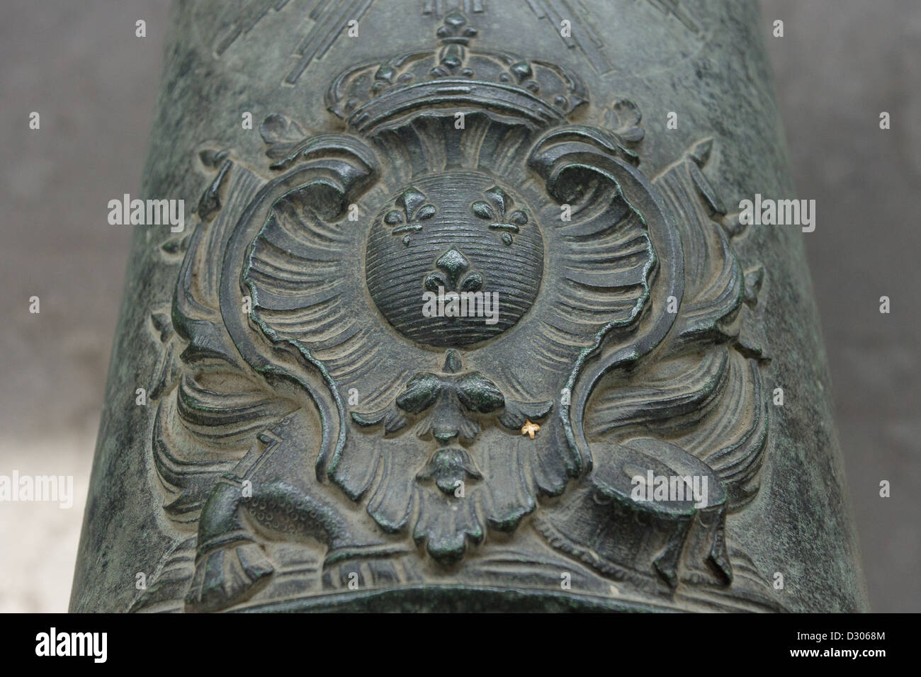 French coat of arms of King Louis XIV (Sun King) on the old bronze cannon. Stock Photo