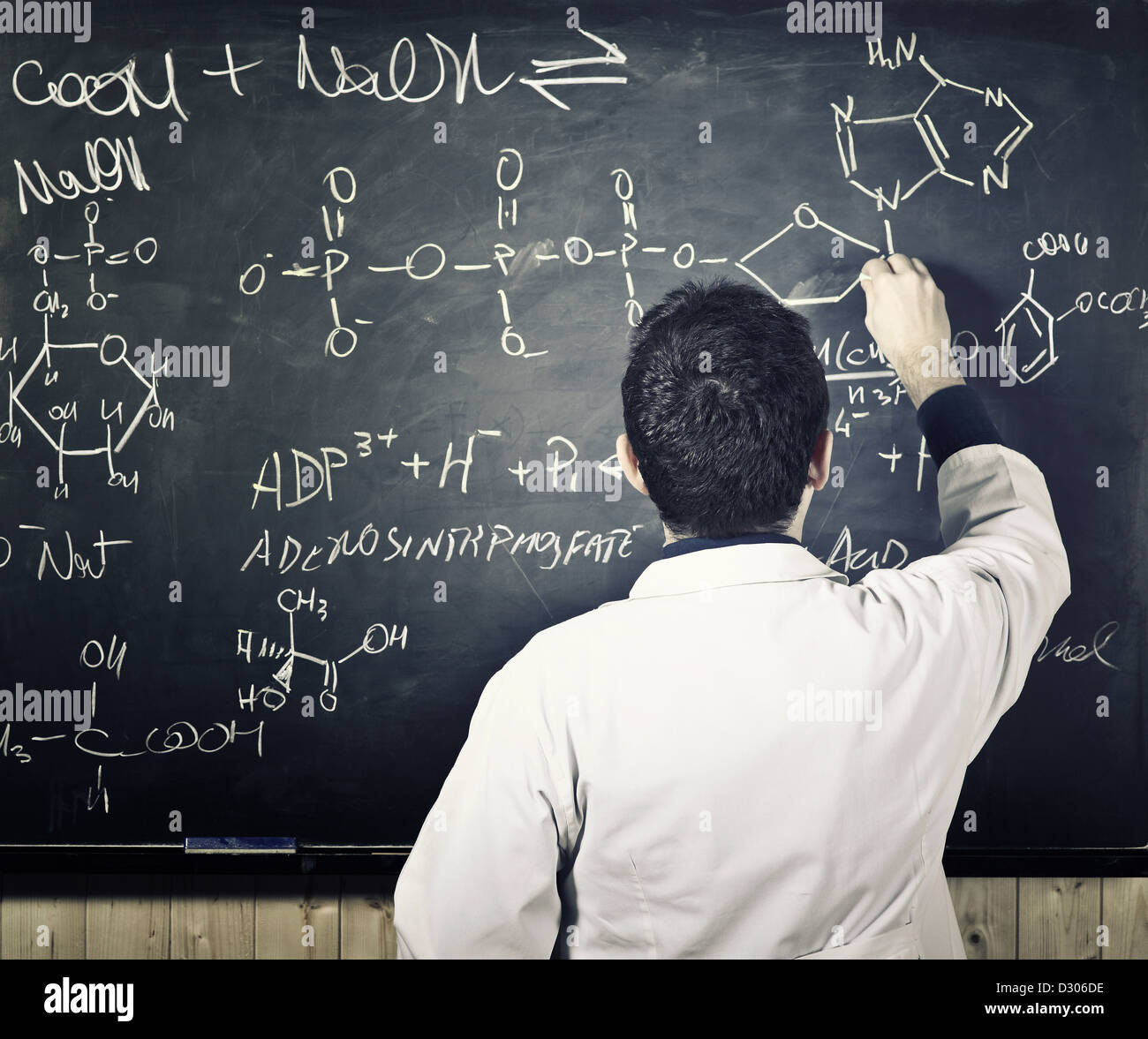 teacher writing on classic blackboard Stock Photo