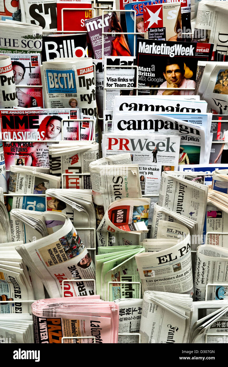 Newspapers and magazines in a rack, UK Stock Photo