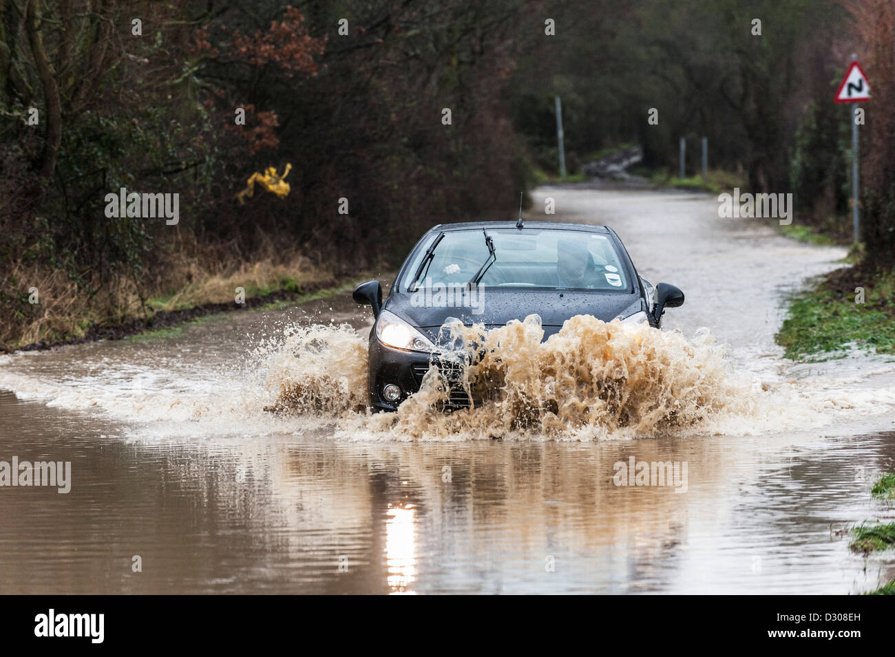 Flooding, UK - car struggles to drive along a flooded road, England, UK Stock Photo