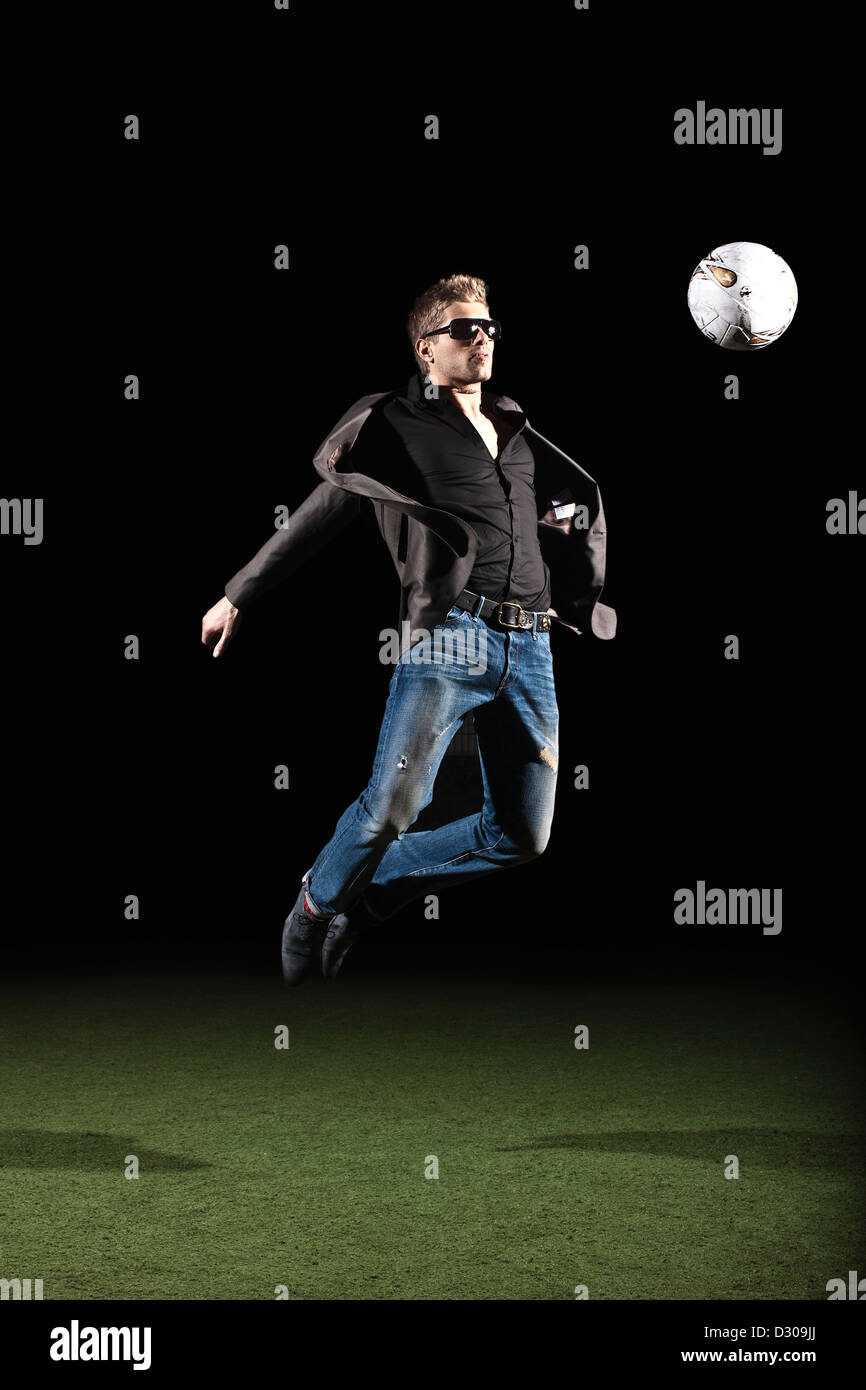 Celebrity footballer in mid air Stock Photo