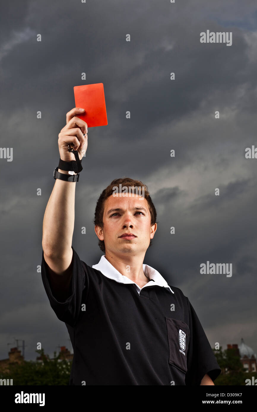 Referee holding red card football Stock Photo - Alamy