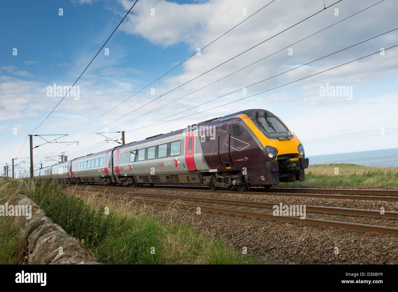 High speed Crosscountry Voyager train on the East Coast Main Line running alongside the coast in the North of England. Stock Photo