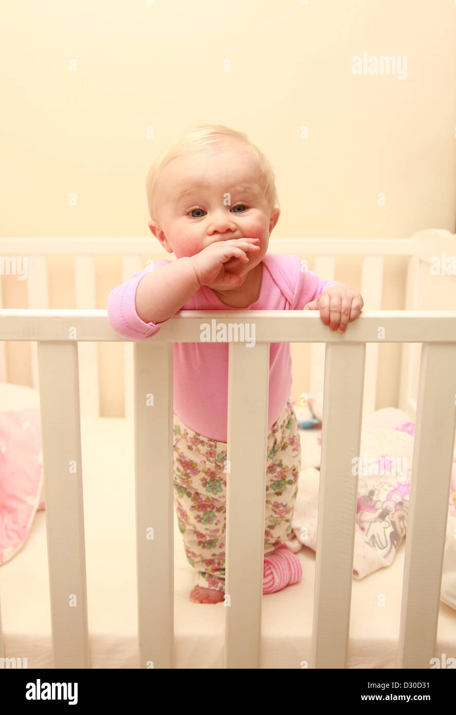 Baby girl in cot not sleeping due to teething Stock Photo Alamy