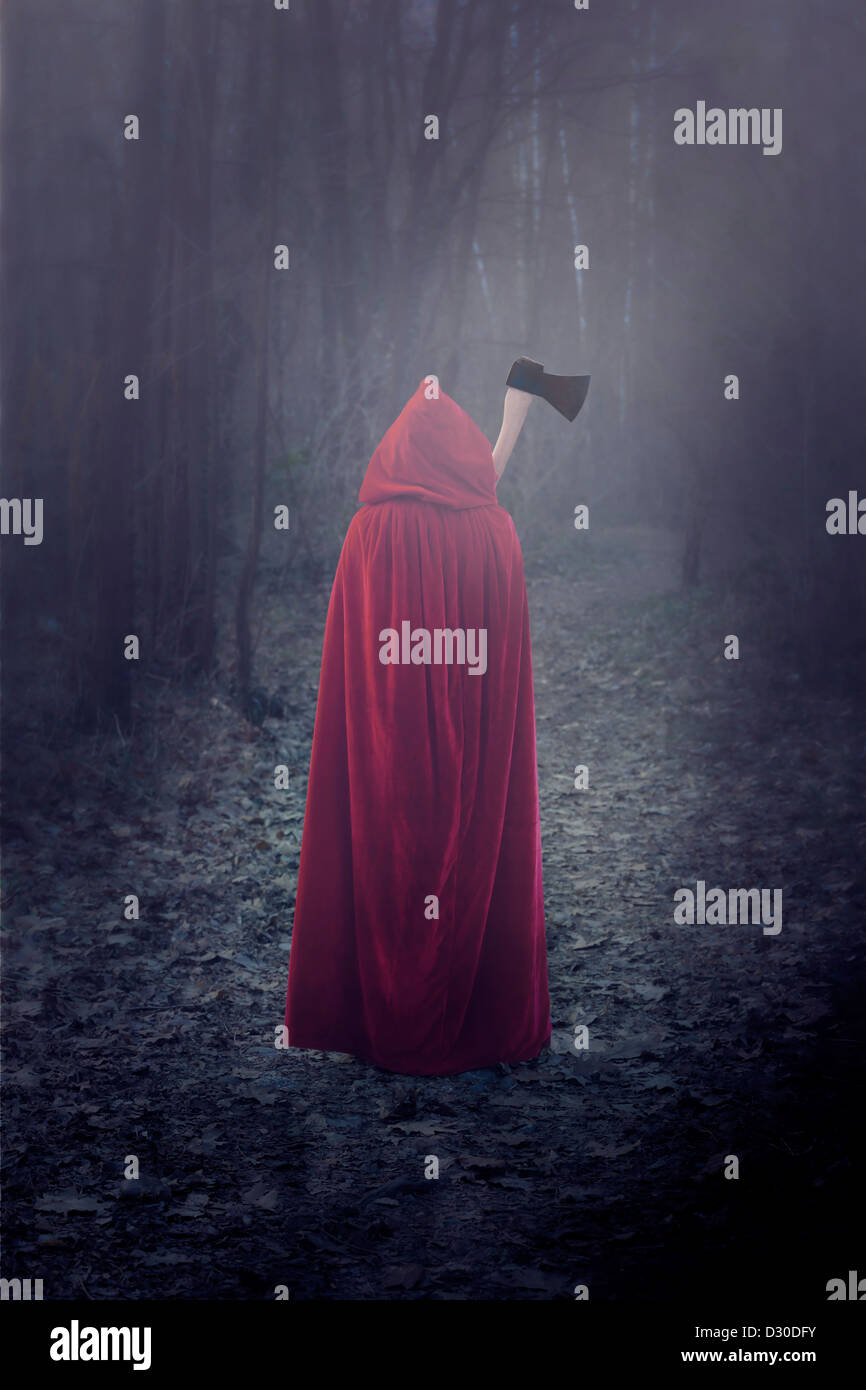 a woman in a red cloak with an axe Stock Photo