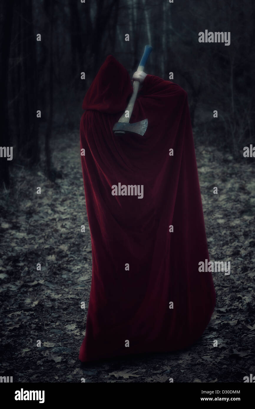 a guise in a red cloak with an axe Stock Photo