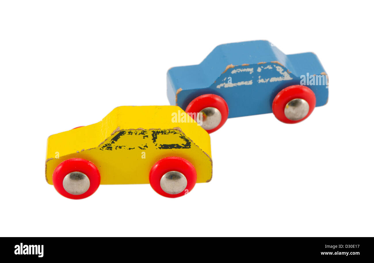 pair of wooden blue and yellow retro vintage toy cars isolated on white background Stock Photo