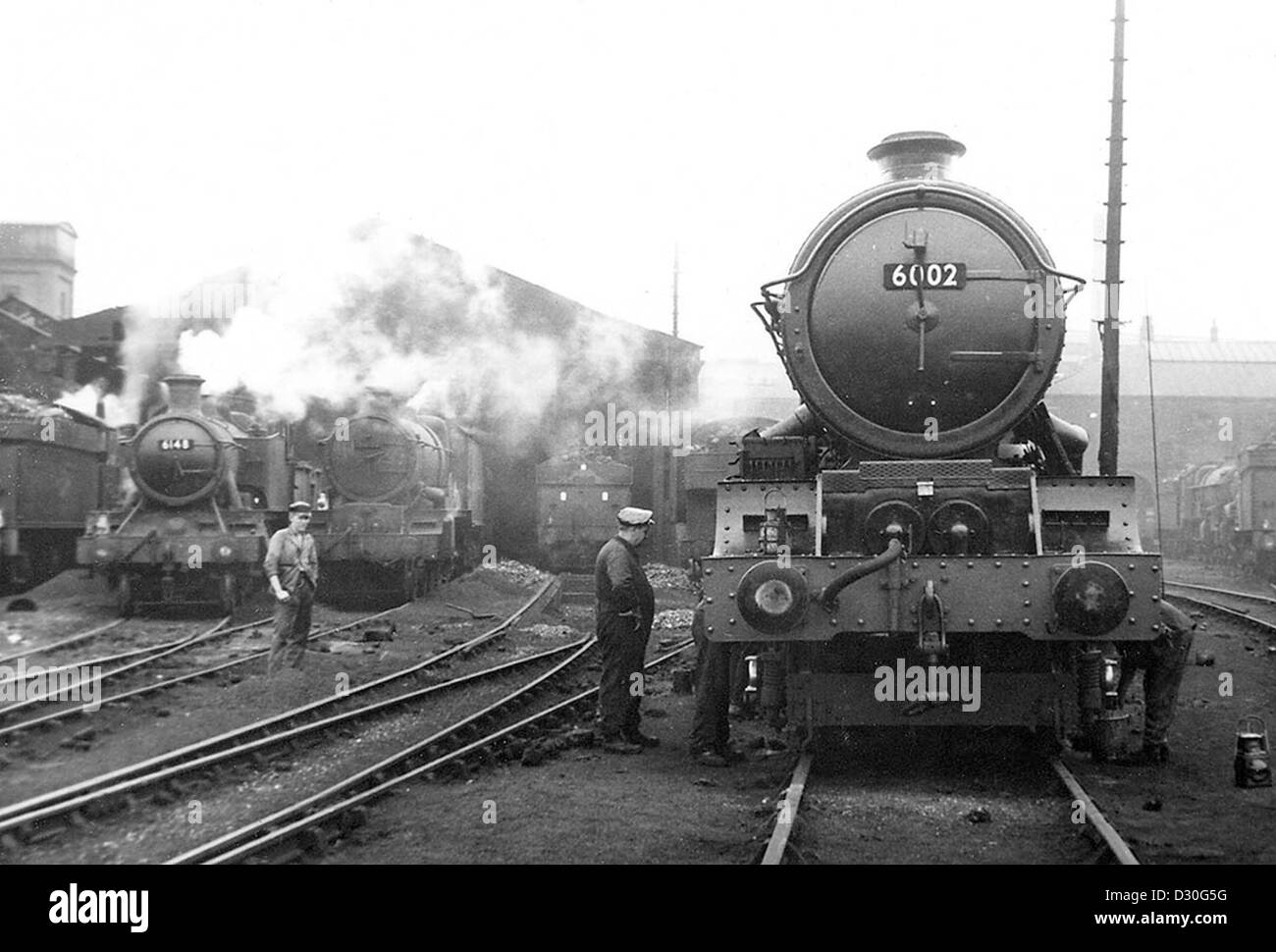 A 'King' class steam locomotive 'King William IV' being prepared at Stafford Road engine shed yard in Wolverhampton 1962. Britain British Railways locomotives engines engine 1960s Stock Photo