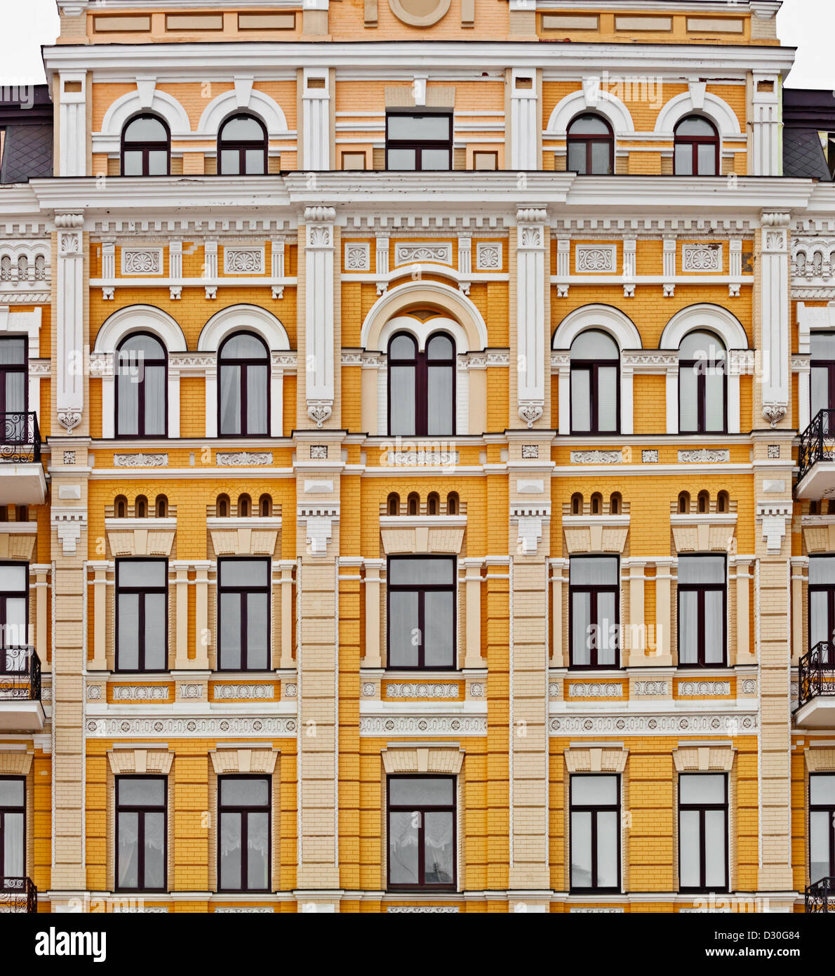 Exterior of european yellow building with many windows, neoclassic architecture Stock Photo